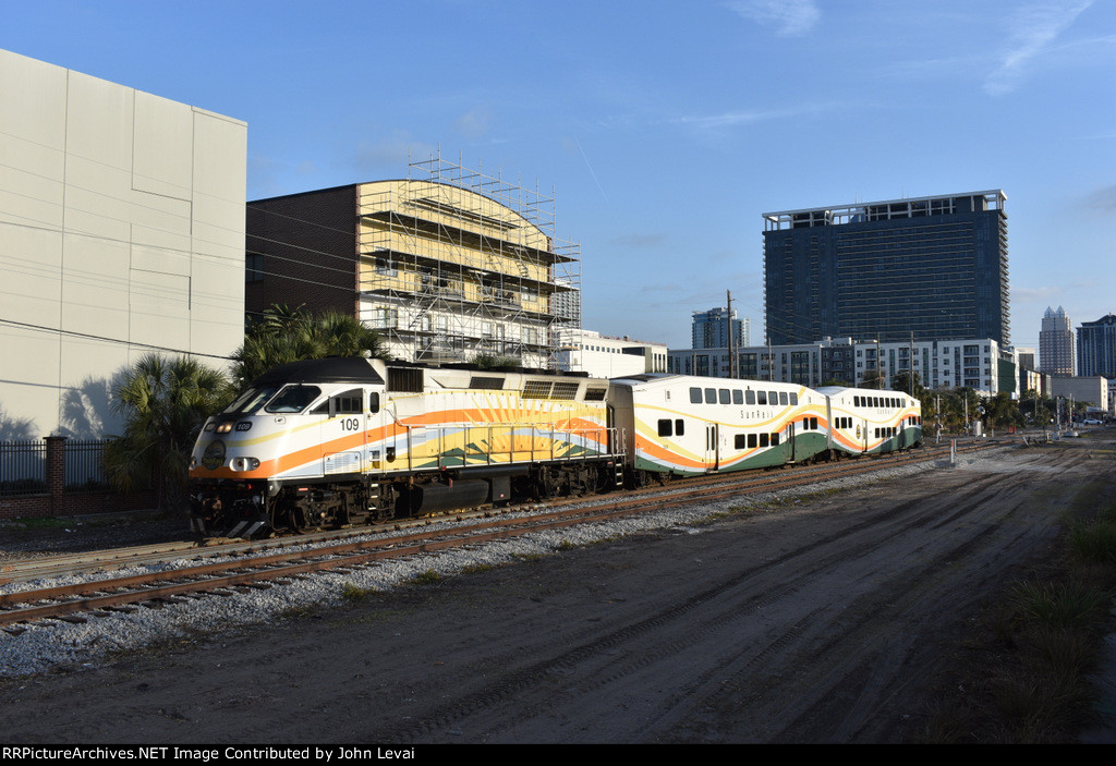 Northbound Sunrail Train # P330 passes alongside the Colonial Opas paths shortly after having departing LYNX Central Station